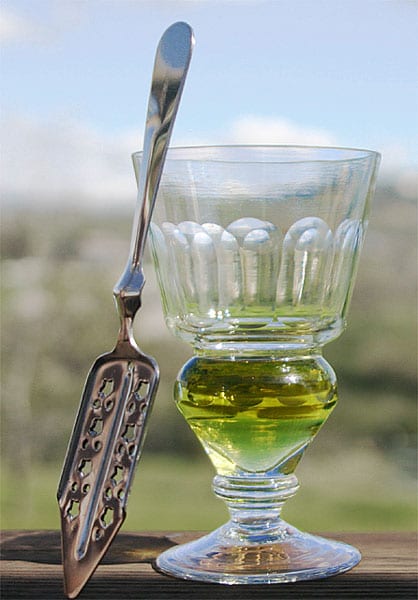 A Pontarlier absinthe glass whose swollen reservoir at the base serves as a dose line