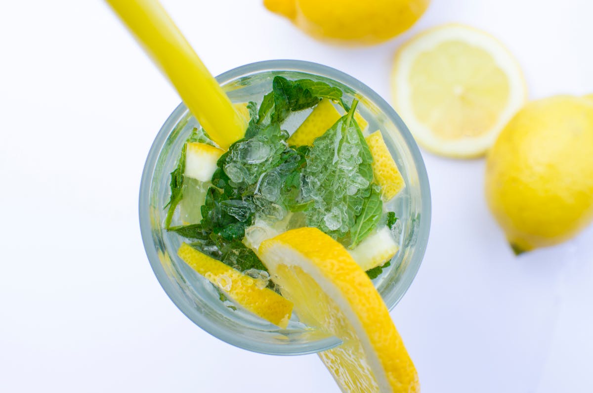 A highball glass with rising carbonation bubbles