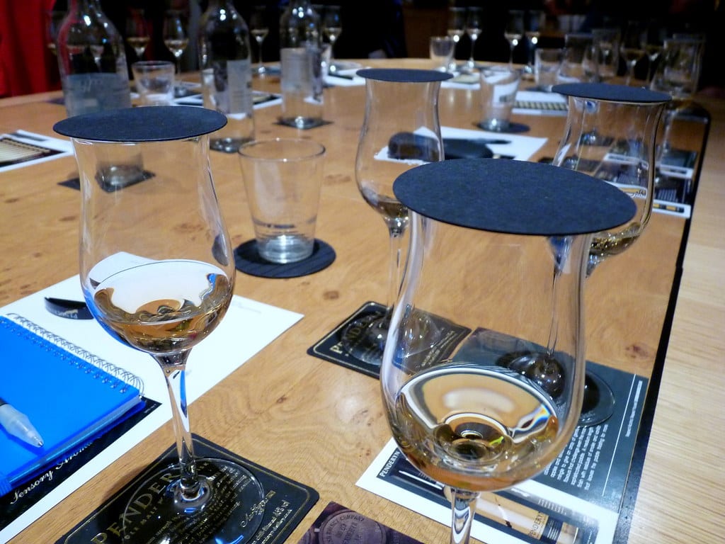 A tasting table lined with covered nosing glasses